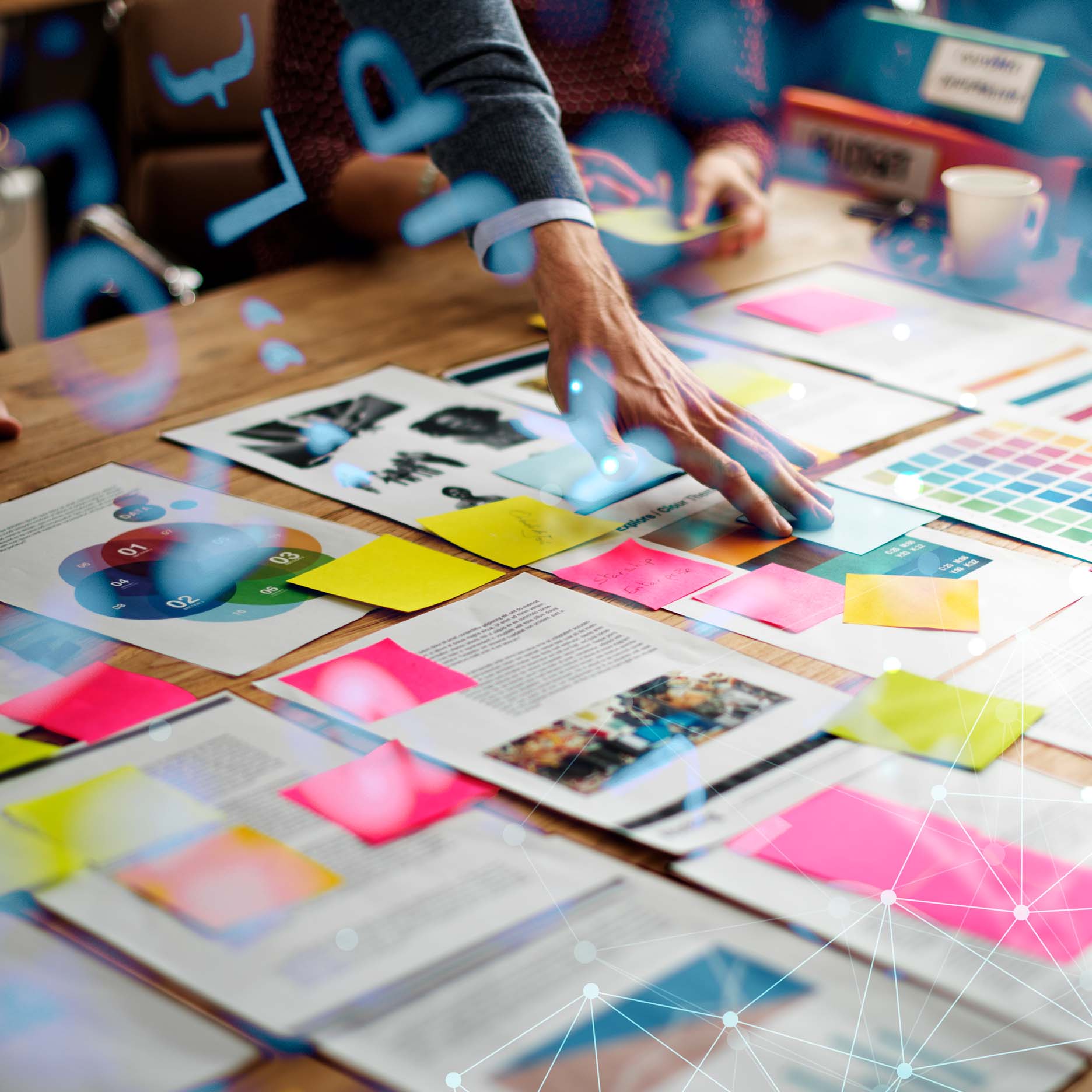 A man placing sticky note on a board laying on a table