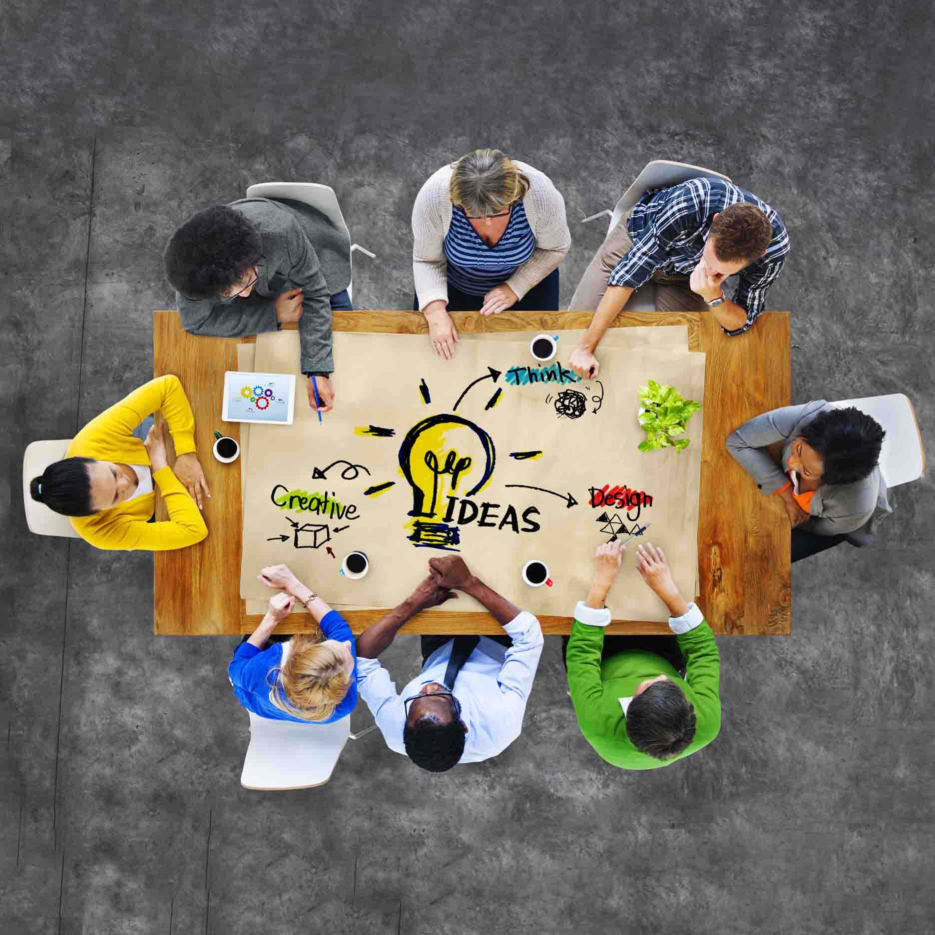 A group of focus group respondents sitting around a table brainstorming.